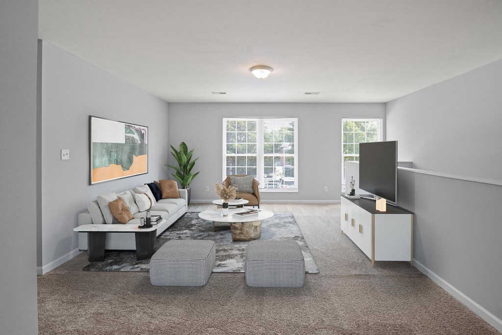 a living room with grey walls and carpet