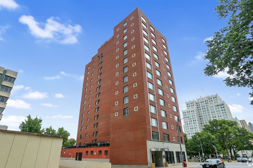 a tall brick building with a blue sky in the background