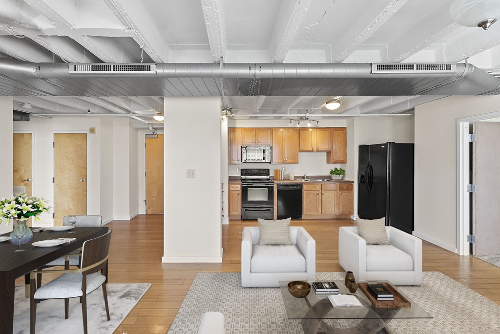a living room and kitchen with white furniture and a table