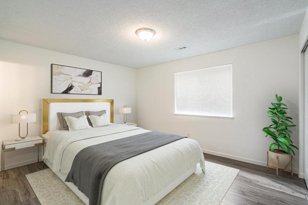 a bedroom with a bed and a window