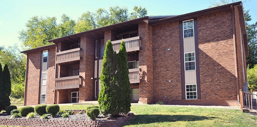 the exterior of an apartment building on a sunny day