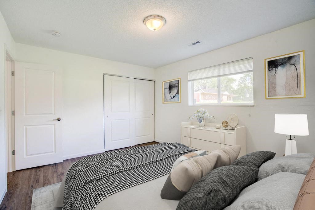 a bedroom with a bed and a window