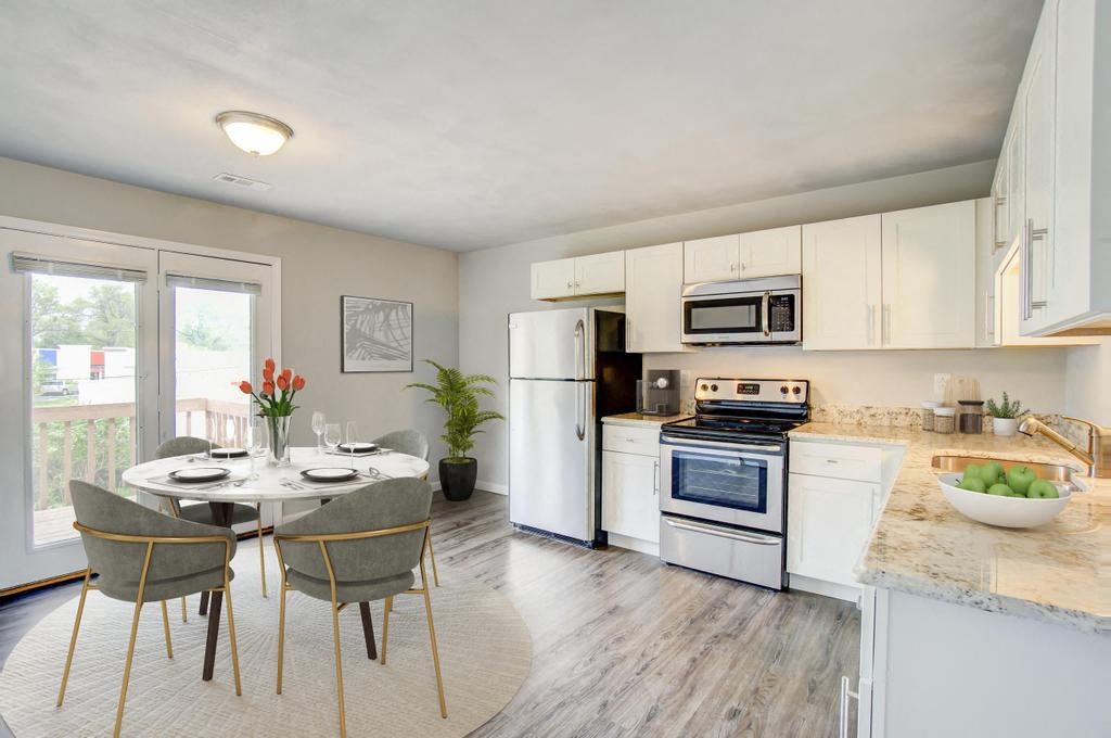 a kitchen and dining area with a table and chairs