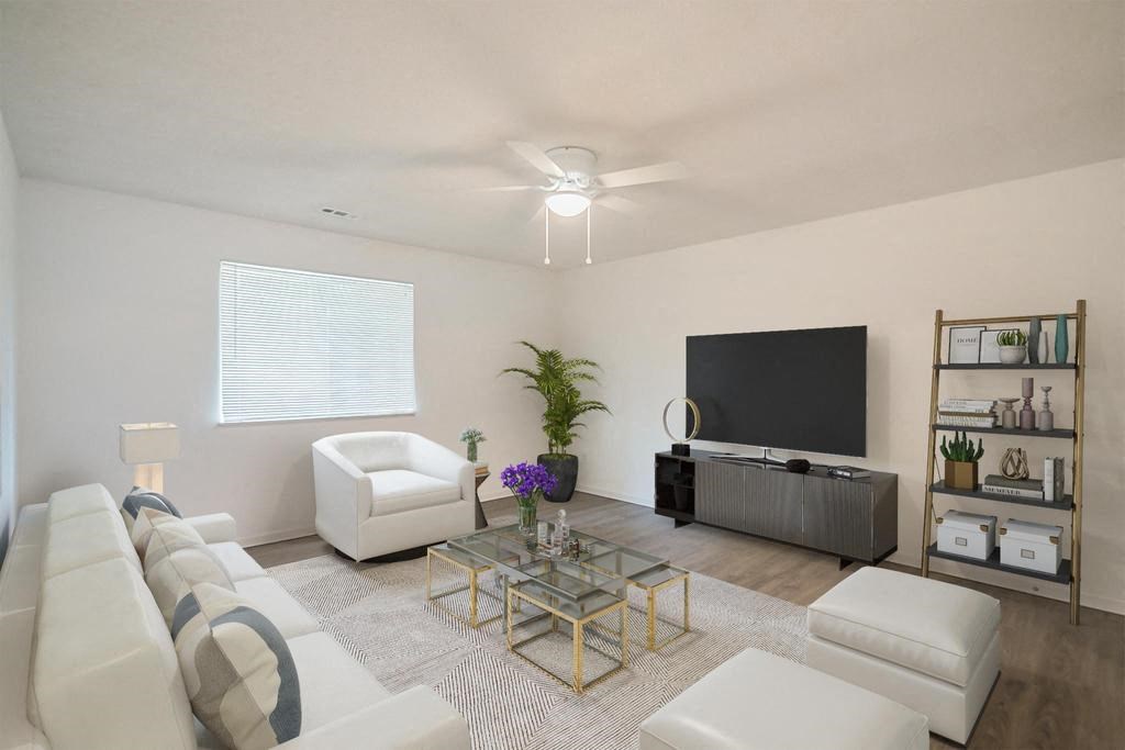 a living room filled with furniture and a flat screen tv