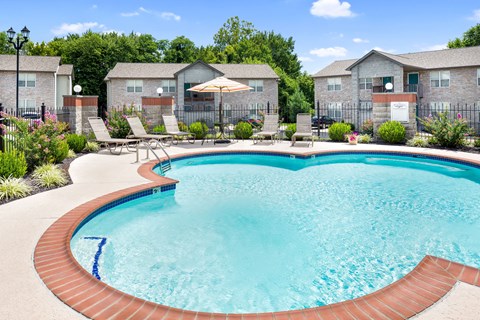 our apartments have a large pool with chairs and umbrellas