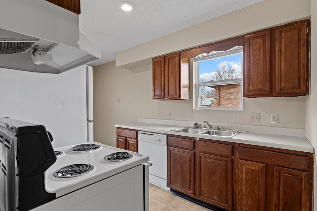 a view of a kitchen with a stove and a window
