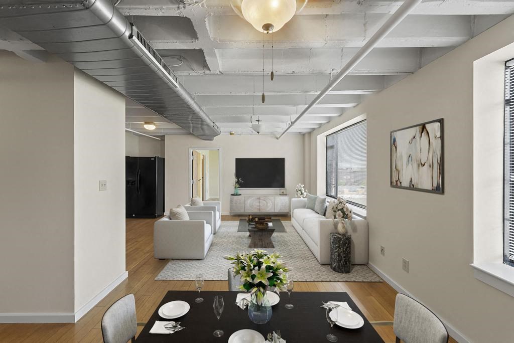 a living room filled with furniture and a large window