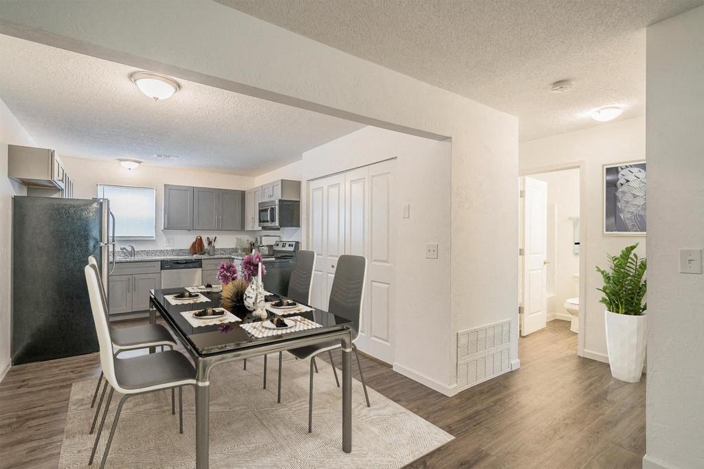 a kitchen and dining room with a table and chairs