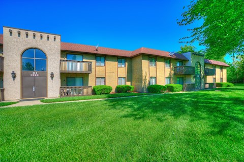 a building with a yard and grass in front of it