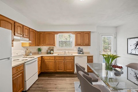 a kitchen with wooden cabinets and white appliances