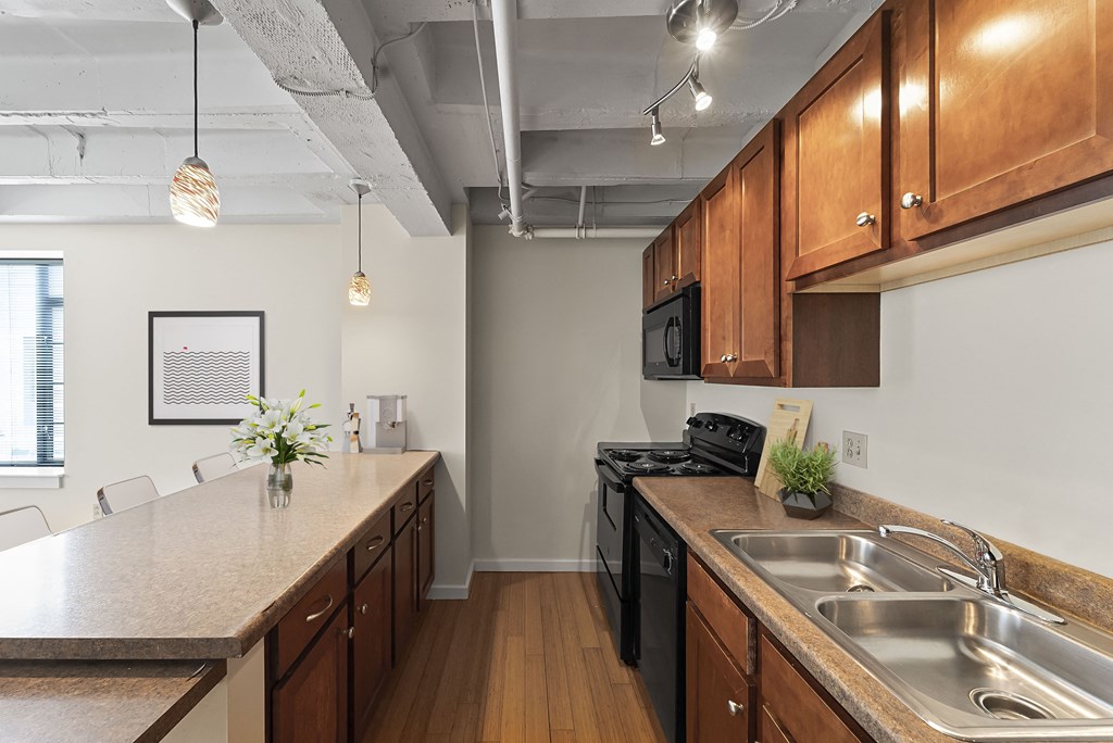 a kitchen with wood cabinets and a counter top and a sink