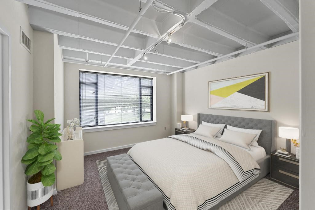 a bedroom with a bed and a window