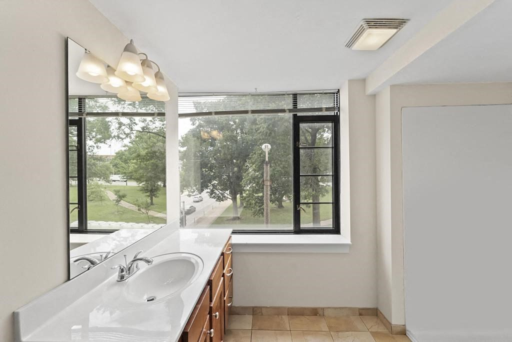 a bathroom with a large window and a sink