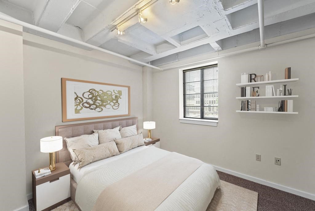 a bedroom with a bed and a window