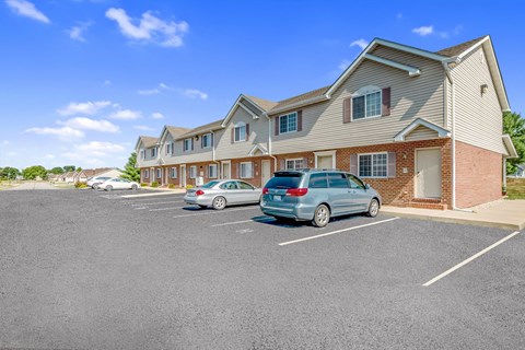 a parking lot with cars parked in front of a building