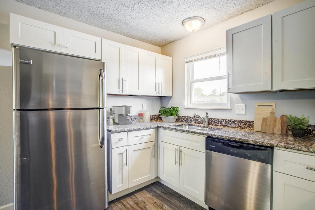 a kitchen with a stainless steel refrigerator freezer and dishwasher