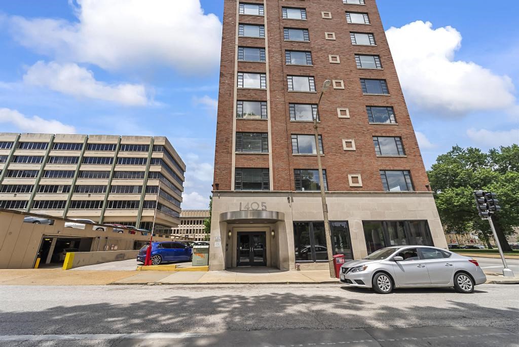a car parked in front of a tall building