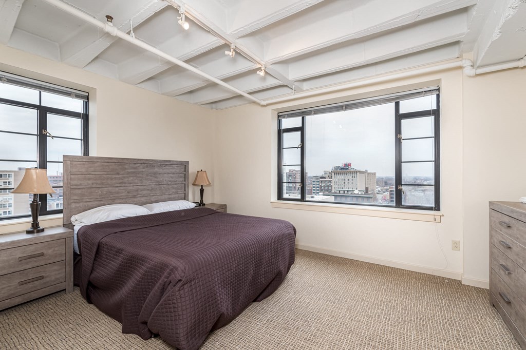 a bedroom with a bed and a window