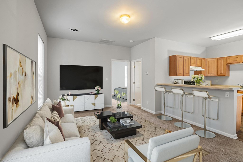 a living room with a couch and a coffee table in front of a flat screen tv