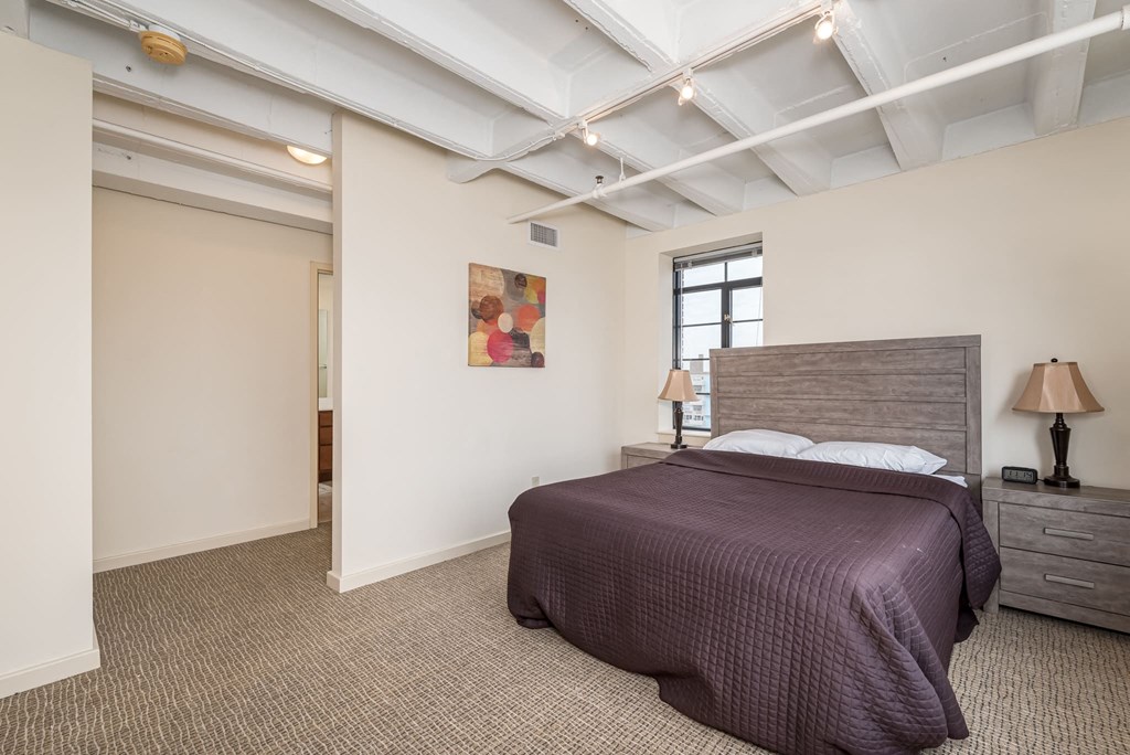 a bedroom with a bed and a window