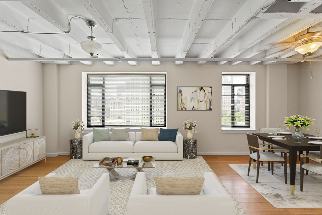 a living room with white couches and a table and a television