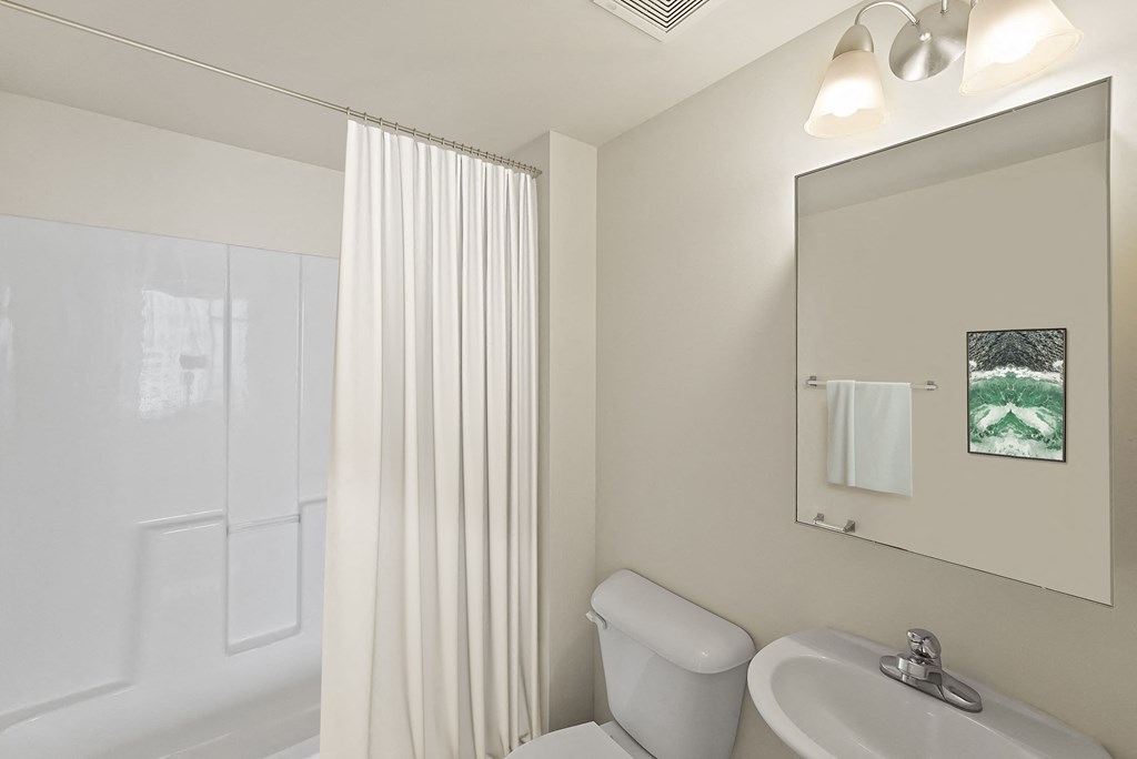 a bathroom with a toilet and a sink and a shower