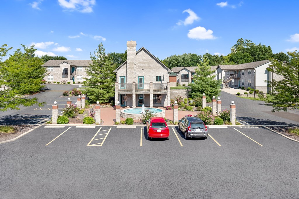 a parking lot with cars in front of a house