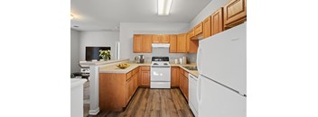 a kitchen with wood cabinets and white appliances