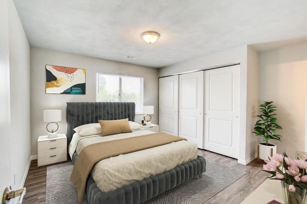 a bedroom with a large bed and a large window