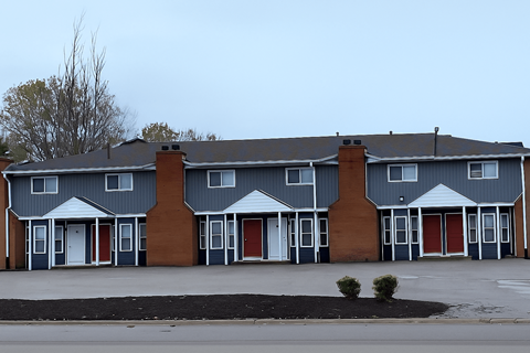 A row of houses with grey and brown exteriors.