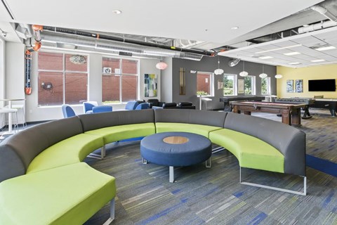 A modern office space with a circular seating arrangement and a long table.