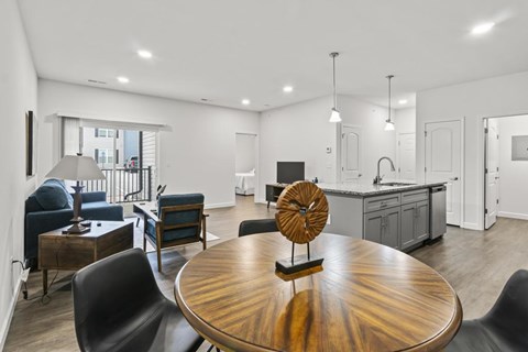 A modern kitchen with a wooden table and chairs.