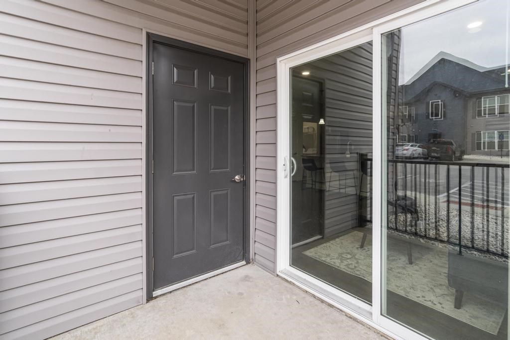 A grey door is on the left and a glass door is on the right.