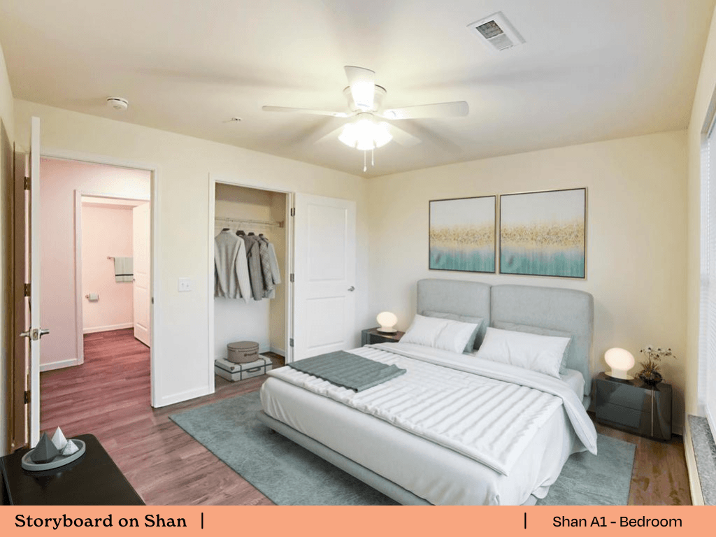 a bedroom with a bed and a ceiling fan and a closet