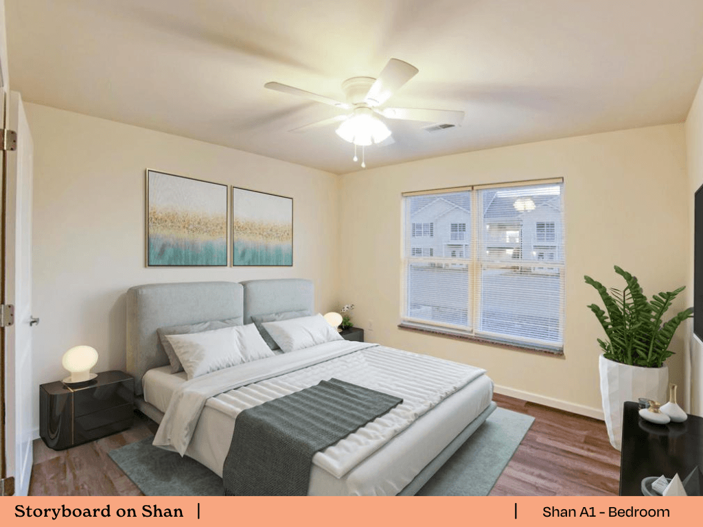 a bedroom with a large bed and a ceiling fan