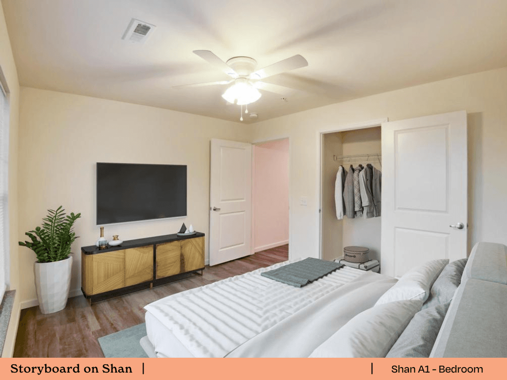 a bedroom with a large bed and a tv