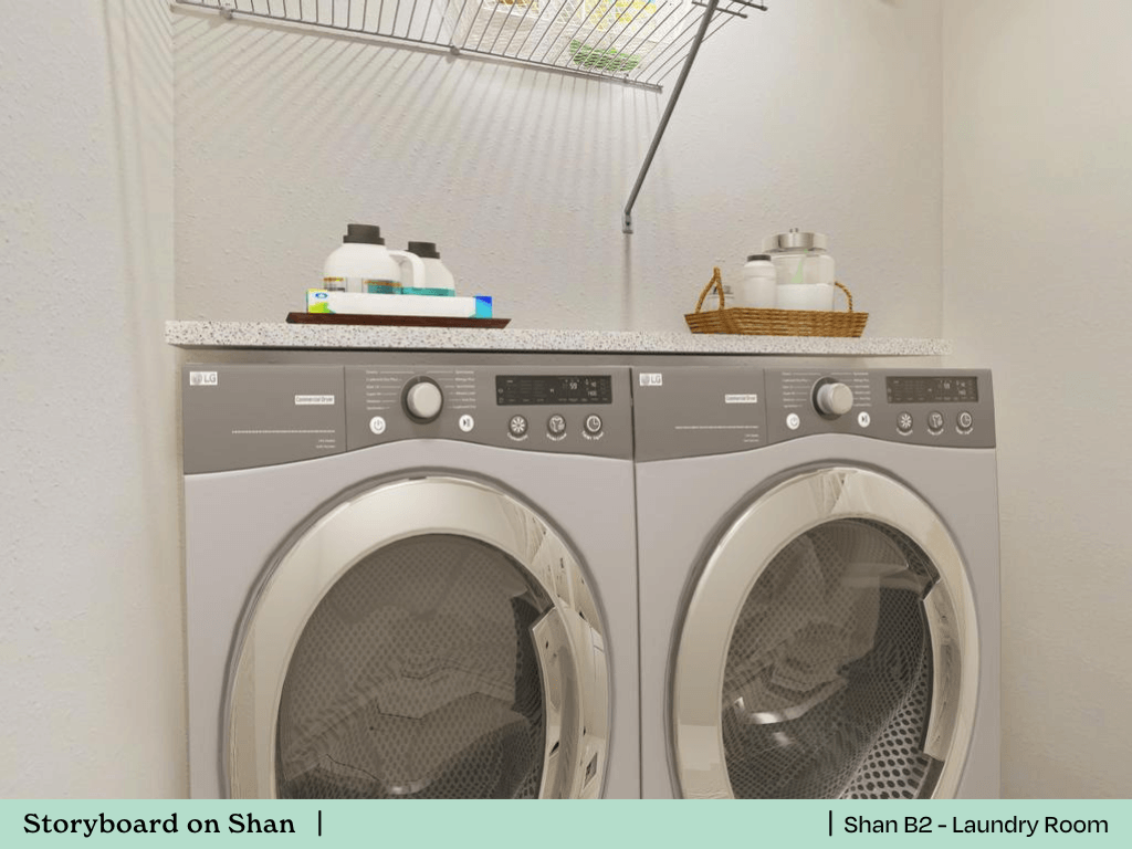 a white washer and dryer in a laundry room with a white counter top