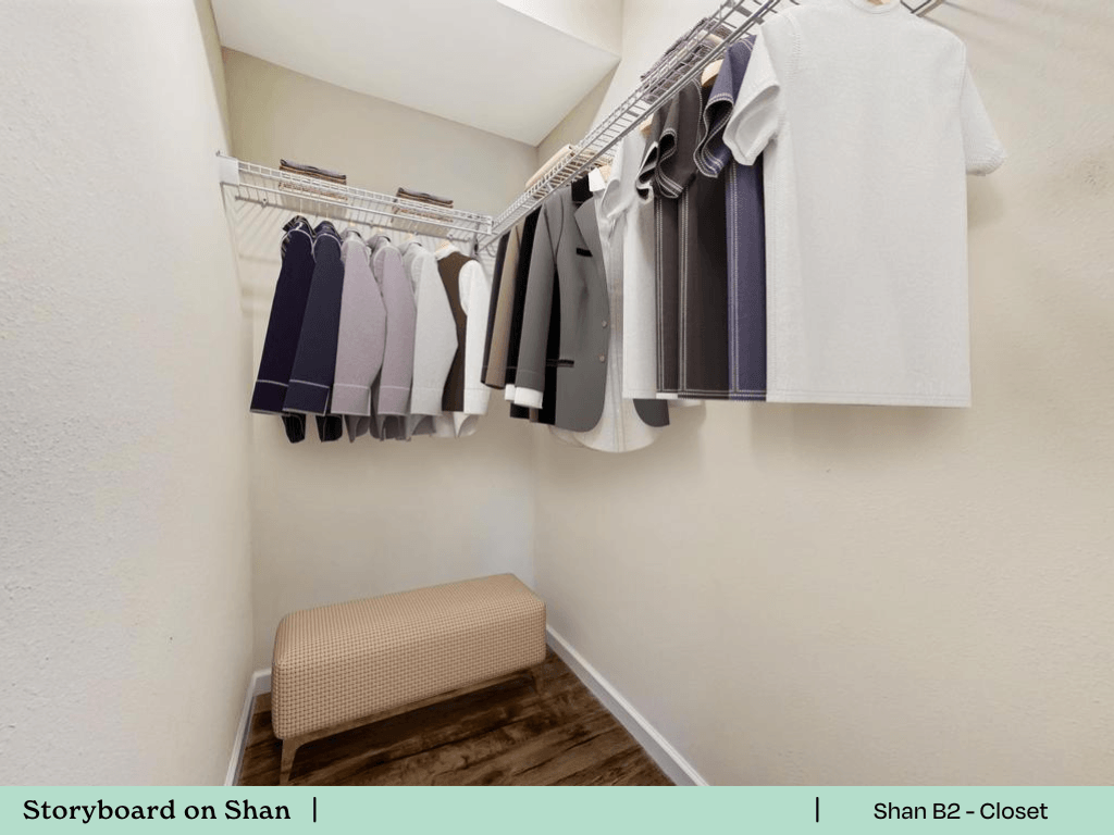 a walk in closet with a rack of clothes