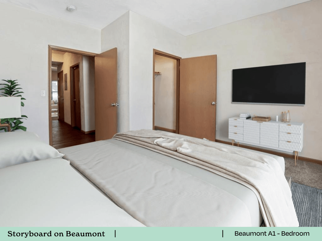 a bedroom with a bed and a tv on the wall