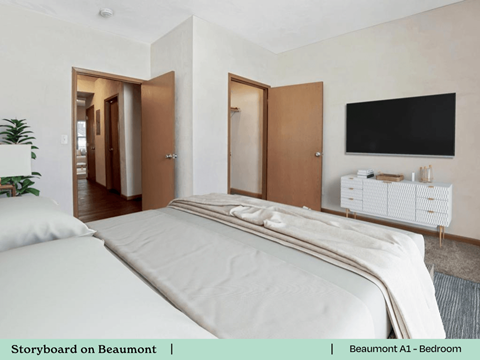 a bedroom with a bed and a tv on the wall