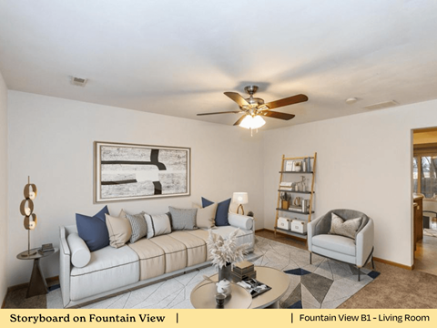 a living room with a couch and a ceiling fan