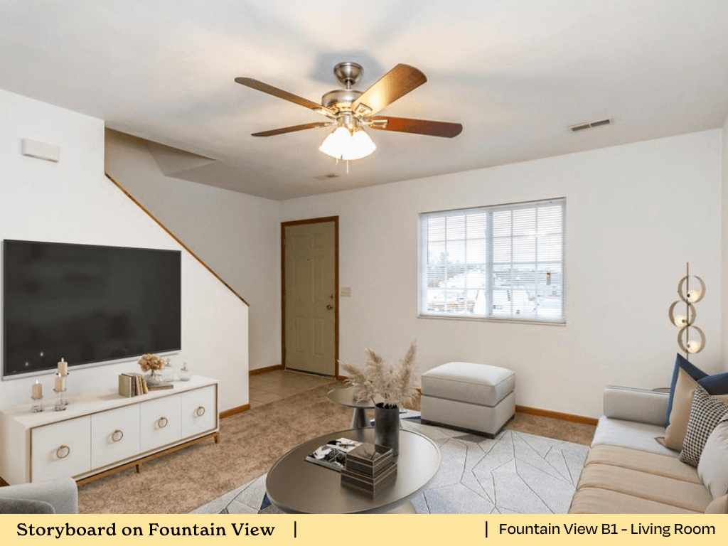 a living room with a ceiling fan and a tv