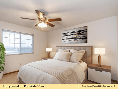 a bedroom with a large bed and a ceiling fan