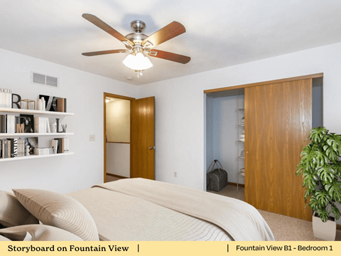 a bedroom with a bed and a ceiling fan