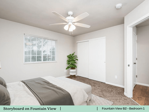 a bedroom with a bed and a ceiling fan
