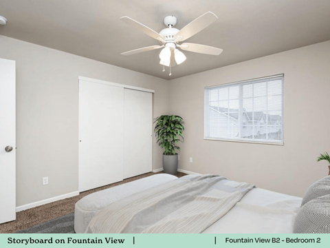 a bedroom with a bed and a ceiling fan