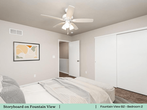 a bedroom with a bed and a ceiling fan