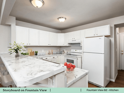 a kitchen with white cabinets and a marble counter top