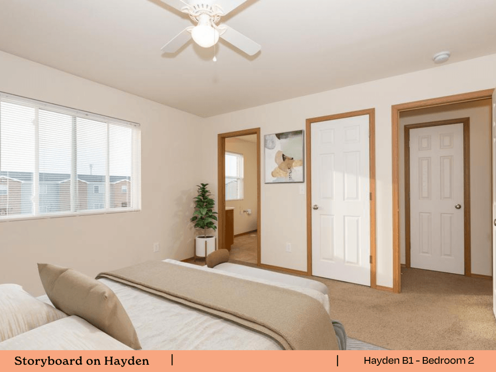 a bedroom with a bed and a ceiling fan