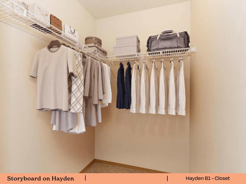 a walk in closet with a rack of clothes and a closet organizer